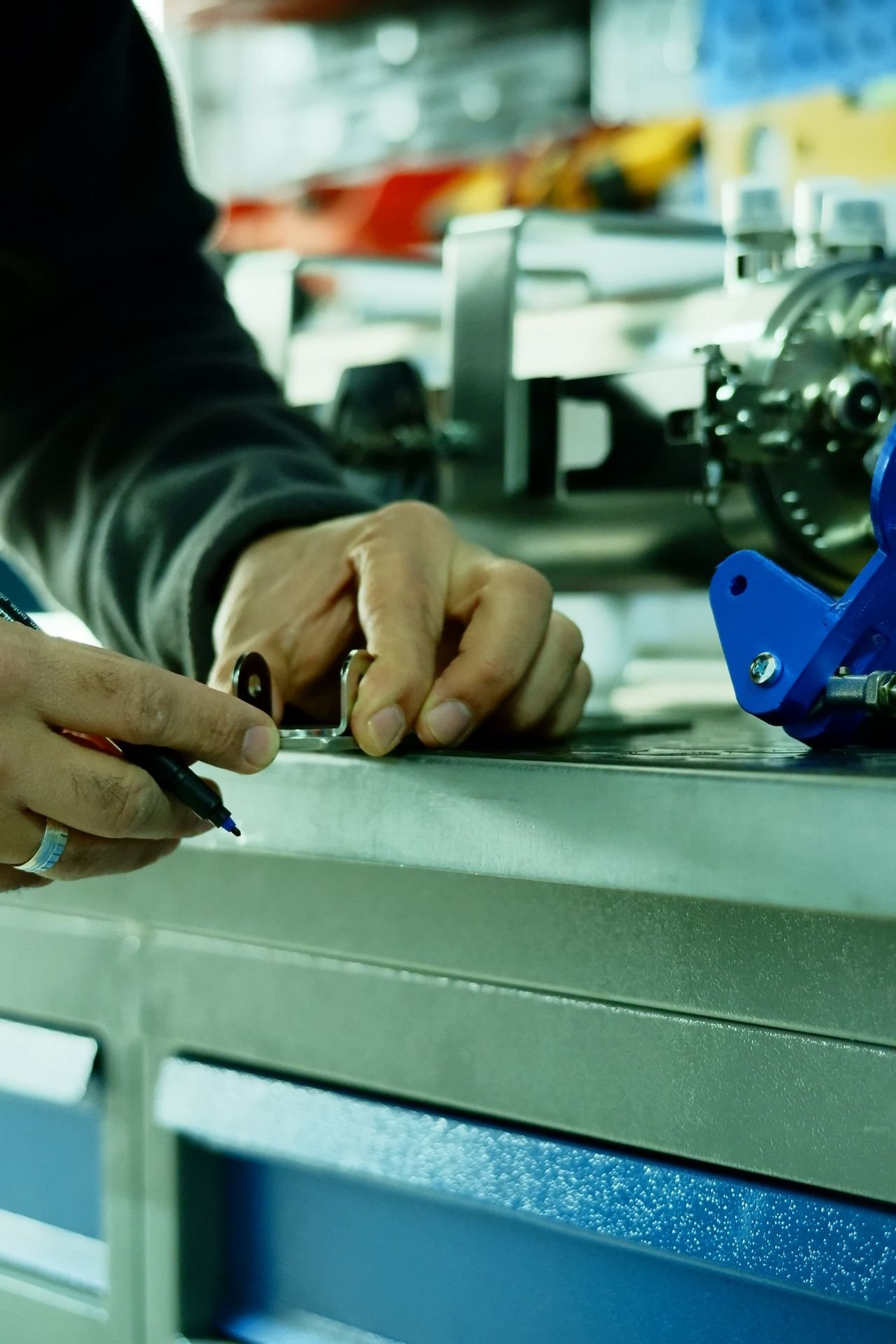 Technician marking and fabricating a suspension bracket on the bench